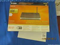 Photo of the router box showing the model WBR-2310 with 108 Mbps speed and RangeBooster G branding.