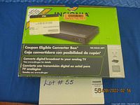 Photo of retail box with Insignia NS-DXA1-APT digital to analog TV converter box image and branding on top side