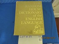 Front cover of The Random House Dictionary of the English Language, green-gold cover with title and house illustration embossed in gold.