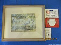 Framed picture of children playing on an outdoor white bench, measuring approximately 13.5 x 11.5 inches, light wood frame; includes a photo of the frame with a package of picture hanger hardware