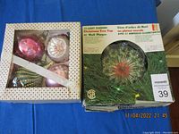 Vintage Christmas tree top and six ornaments in original boxes and loose, showing condition and packaging.