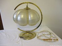 Full view of the vintage table lamp with glass shade on brass frame and base, showing the shape and design.