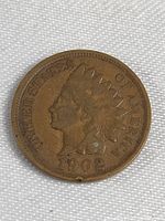 Obverse view of the 1902 Indian Head penny showing Lady Liberty with Native American headdress and the date 1902.