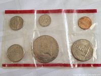Sealed 1976 USA Mint Bicentennial coin set showing six coins in plastic packaging with red border strip.