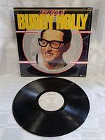 Front cover of 'The Best of Buddy Holly' vinyl LP record featuring a portrait of Buddy Holly with his signature glasses and bold title text.