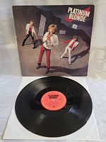 Vinyl record with red 'Platinum Blonde' label laid out in front of the cover showing the record condition.