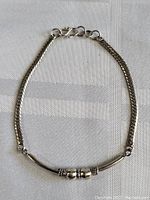 View of the sterling silver bracelet laid flat showing clasp and chain detail.