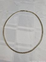 Full view of the sterling silver thick Italian link necklace laid flat showing the entire chain and clasp.