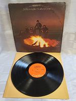 The vinyl disc of The Band Northern Lights Southern Cross with orange Capitol label, black vinyl showing clean surface.