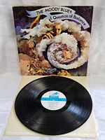 Overall front view of "A Question of Balance" album cover with the vinyl record resting in front, showing the label side of the record.