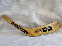 Full view of the wooden hockey stick blade showing full length with EASTON logo and Wayne Gretzky name/number in black.