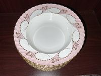 Full stack overhead view showing the white interiors and decorative pink and gold scalloped rim edges of the Royal Tettau bowls.