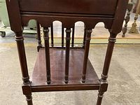 Photo showing the turned legs and dovetail corner construction of the table.