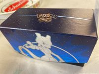 Box with Pokémon Go logo and Mewtwo artwork on the lid, used for card storage.