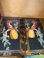 Pair of matching bird-themed framed prints showing colorful birds on branches with dark wood carved frames.