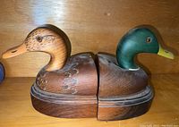 Pair of hand carved and painted wooden duck decoy bookends, side by side, showing the full set.