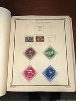 Page of Hungary stamps with various colorful diamond-shaped designs and historical subjects from the 1940s.