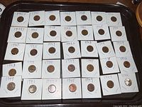 Overview of all 36 wheat pennies from the 1940s in 2x2 holders showing dates