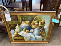 Full front view of the framed oil painting showing the still life scene with bowls, basket of fruit, and teapot on a table.