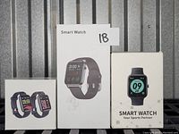 Photo showing three boxed black silicone strap smart watches, each with chargers and instructions, as per seller description.