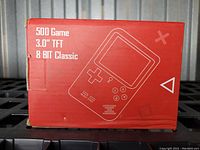 Box front showing product name, 3-inch TFT screen, and 8-bit classic game console illustration.