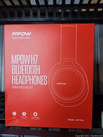 Photo of the front of the MPOW H7 Bluetooth Headphones box, showcasing brand, model, and key features.