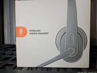 White and orange box showing illustration of a Taotronics wireless mono headset with microphone boom.