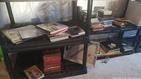 Wide shot of plastic shelving units with stacks of magazines, books, and CDs arranged on shelves.