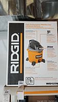 Photo of box showing Ridgid branding and image of the 12 gallon wet/dry vacuum Cleaner Model WD1278