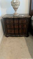 Front view of full dresser showing wood finish, drawer configuration and marble-look top