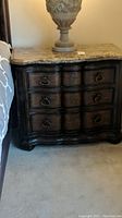 Full front view of dresser showing serpentine-front drawers and dark wood finish