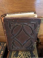 Front cover view showing embossed brown leather design