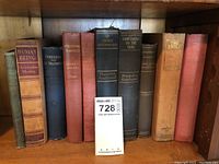 Shelf view of antique literary and historical books showing titles and varies spine conditions.