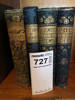Four cloth-bound hardcover volumes with gilt decoration and titles on spines displayed together