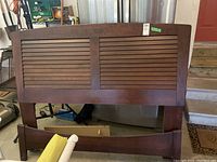Headboard and footboard with a dark wood horizontal slat design, showing the main decorative elements of the bed frame.