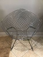 Front view of the chrome wire diamond pattern chair showing its shape and design.