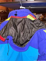 Photo of the interior lining and hood showing construction, drawstring adjustments and material texture and colors.
