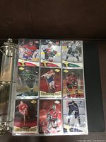 Front view of binder page showing nine Upper Deck hockey cards including Montreal Canadiens, Calgary Flames, and St. Louis Blues.