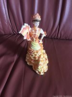 Front view of the Royal Doulton figurine 'Le Bal', showing detailed dress and fan.