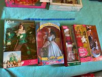 Front view of the full lot showing all five boxed dolls: Ken Scarecrow, Cinderella Barbie, Santa Barbie, Coca Cola Party Barbie, and Halloween Glow Barbie.
