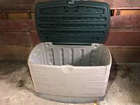 Open view of Rubbermaid deck box showing interior and hinged lid.