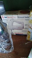 Photo of the Sunbeam Mixmaster hand mixer box showing it is a 6-speed model with beaters and attachments.