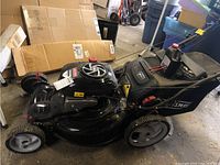 Full side view of black Craftsman push mower with grass catcher bag attached