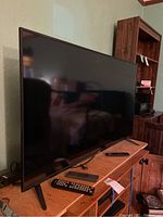 Side view of the Vizio flat screen TV showing its thin profile and angular legs.