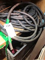 Photo showing coiled thick black water resistant 10/3 gauge wire inside a crate.