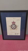 Frontal view of the framed Air Operations Branch logo print with signatures