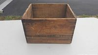 Front view of wooden crate showing faded text 'Sweeten It'.