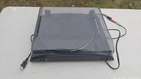 Ion Profile Pro USB turntable with the dust cover in closed position, showing overall condition and cords.