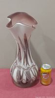 Full view of the tall art glass vase with ruffled top edge and swirled mauve, white, and brown pattern.