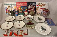 Wide shot showing entire lot including plates, books, figurines, tin, mug, and small bottles